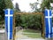 Entrance to orhtodox church of Agia Paraskevi in Metsovo, Epirus, Greece. Greek flags.