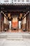 Entrance to an ornate traditional Chinese building with an intricate rug hung on the inside wall