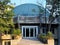 The entrance to the Planetarium and the Museum with a domed roof among the green trees and yuccas against the blue sky