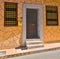 Entrance to a residential building with an entrance door and windows, made in the style of Moroccan art traditions