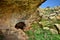 Entrance to a small cave formed in a valley, in Maltese limestone, Ghar il-Buz, Malta