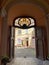 Entrance to the tenement house through a gate with a beautiful door and a paving stone floor