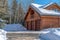 Entrance to three door garage of Park City home with gable roof and wood wall