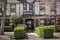 Entrance to upscale half timbered house with hedges and landscapeing  in early spring - curb appeal