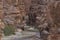 Entrance to the Wadi Mujib canyon in Jordan. Steep rocks and a rapid flowing river carved. Difficult crossing and attraction for