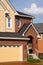 Entrance in two-storied brick cottage with garage