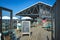 Entrance with welcome sign to beautiful rustic wooden and teal colored interior design of `Paal 19` beach pavilion terrace on isla