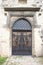 Entrance wooden gate to the castle with knockers