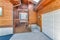 Entrance of a wooden house with white front door and garage