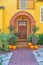 Entrance of a yellow house with iron single gate and arched bricks columns- San Francisco, CA