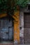 Entrance of yellow old colonial building with wood