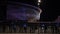 Entrances to the football stadium at night. Stock footage. Large glowing football stadium at night