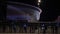 Entrances to the football stadium at night. Stock footage. Large glowing football stadium at night