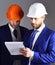 Entrepreneur and architect wearing helmets.Construction, business, confidence, partnership concept.