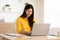 Entrepreneur beautiful business asian young woman wear yellow shirt work online with laptop at home.Freelance woman working online