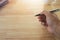 Entrepreneur hand holding a pen on a wooden desk