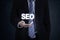 Entrepreneur hand holds SEO word