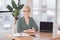 Entrepreneur Lady Sitting At Laptop With Empty Screen At Workplace