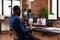 Entrepreneur using online video call to talk to woman on laptop for project planning