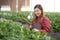 Entrepreneur young asian woman check cultivation strawberry with happiness and writing on note for research in farm.