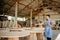 entrepreneurial man works in a woodcraft shop using a tablet