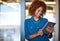 Entrepreneurs doing what they do best. a smiling young professional standing in a modern office using a digital tablet.