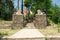 Entry gate with stone entrance lion statue and flags