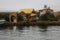 The entry gate to one of the man made islands of Lake Titicaca in Peru, South America with many boats in fronts of it