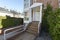 Entry of a single family home with stairs to a covered doorway