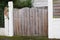 Entry wooden gate high closed of private house suburb wood portal access home door