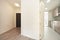 Entryway and foyer with door to kitchen with cherry cabinets, white countertop,