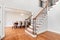 An entryway looking towards a dining room and staircase.