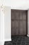 Entryway mudroom with wood cabinets and hexagon tiled floor.