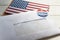 Envelope containing voting ballot papers being sent by mail for absentee vote in presidential election and USA flag