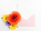 Envelope with meadow flowers and red poppies, green leaves on white background. Top view. Flat lay