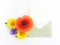 Envelope with meadow flowers and red poppies, green leaves on white background. Top view. Flat lay