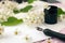 Envelope, paper, white flowers, black ink and fountain pen. Styled feminine desk workspace with white flowers, calligraphy nib