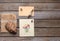 Envelope, postcard and mask on a wooden background