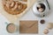 Envelope, potter, coffee cup, seashells, and Apple pie on white wooden table. Flat lay food