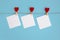 Envelope and red hearts, hanging on line against blue background