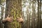 Environment and respect for Earth nature concept - adult woman hugging a green tree in the forest - save the planet and climate