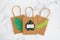 Environmental awareness and consumer behaviour concept, Sustainable Product text on shopping bag with tropical green paper leaves