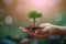 Environmental bond Hand and tree unite on a nature background