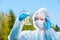 environmental chemist in protective clothing and glasses examines water