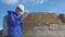 Environmental pollution. man chemist scientist in a respirator mask studies landfill dump pollution radioactive waste