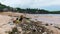 Environmental pollution. Ocean beach with plastic waste. Mother and child picking up garbage for recycling.