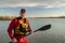 Environmental portrait of a senior male paddler in a drysuit