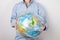 Environmental protection. Tarnishing the planet. A woman holds in her hands the planet Earth in the form of a globe in a