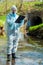 environmental scientist with a walkie-talkie and a notebook on the background of a sewer