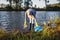 Environmental volunteer cleaning river from plastic garbage